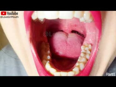 Girl with beautiful mouth, lipstick and teeth, chewing a chewy candy with her molars tongue uvula